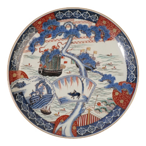92 - A JAPANESE PORCELAIN CHARGER decorated in polychrome enamel underglaze blue and gilt with European m... 