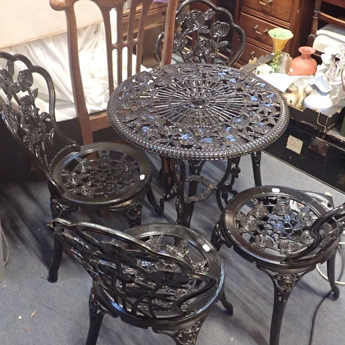 11 - A MODERN CAST METAL GARDEN SET table and four chairs