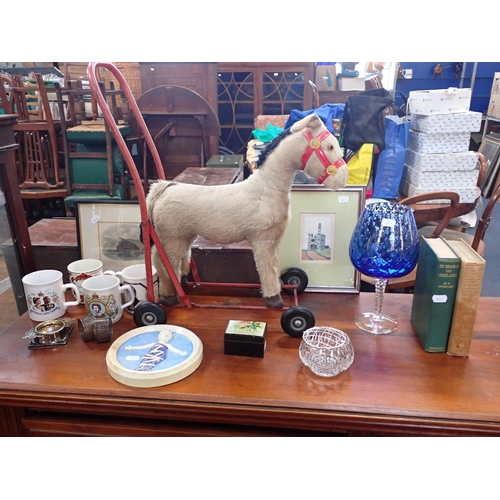 24 - A CHILDS STUFFED DONKEY ON WHEELS with a collection of domestic items, prints and a stamp box