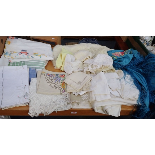 30 - A COLLECTION OF TABLE LINEN with an embroidered shawl, a fur jacket and baby knitwear