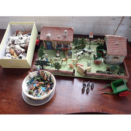 44 - A WELL EQUIPPED TOY FARM with original buildings and yard, with animals, people, carts etc. mostly p... 