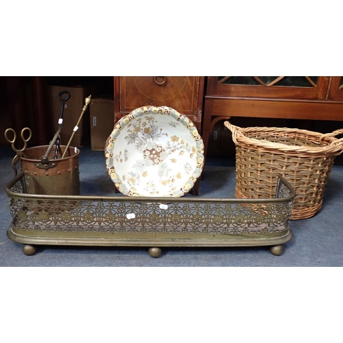 45 - VICTORIAN PIERCED BRASS FENDER with a brass and copper bucket, fire tools, a wicker log basket and a... 