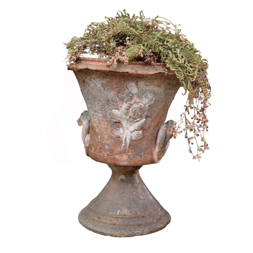 6 - A TERRACOTTA URN with a floral motif to the front, planted with a fern, 45cm high