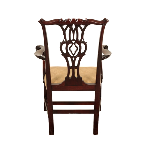 104 - A GEORGE III MAHOGANY CHIPPENDALE STYLE ARM CHAIR 19th century, the shaped cresting rail over a pier... 