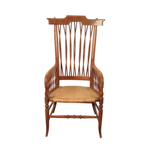 137 - AN EDWARDIAN COMB BACK ARMCHAIR early 20th century, with a wicker seat, 103cm high x 52cm wide