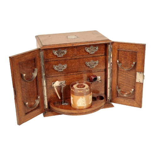 160 - AN EDWARDIAN OAK SMOKER'S CABINET the plaque at the top is inscribed 'E. H. S. 23rd Novr 1912', the ... 