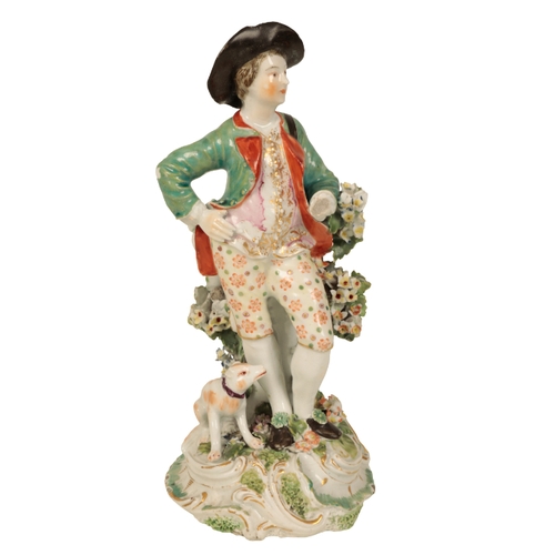 194 - AN 18TH CENTURY DERBY FIGURE OF A GENTLEMAN with a dog at his feet, and bocage, 21cm high, damages a... 