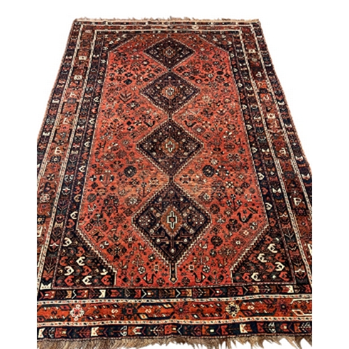 219 - A NORTH WEST PERSIAN CARPET early 20th century, the brick red ground with four central medallions, w... 