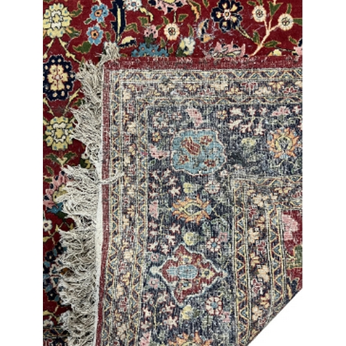 389 - A NORTH WEST PERSIAN TABRIZ STYLE CARPET 20th century, with all over repeating stylised flora, withi... 