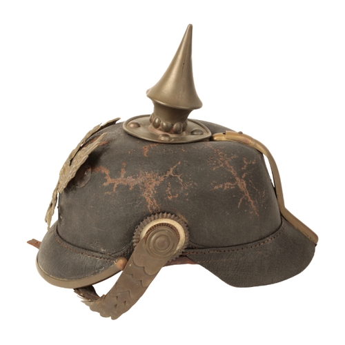 57 - A WWI PRUSSIAN PICKELHAUBE HELMET with the original brass and leather chin-strap and gilt eagle helm... 