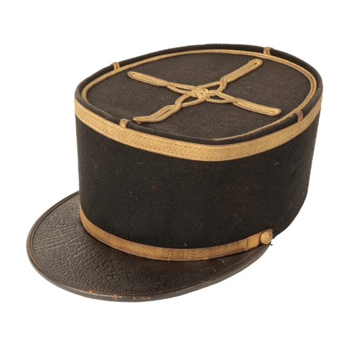 81 - A LATE 19TH CENTURY FRENCH KEPI with leather peak and gilt bordered decoration to the top.