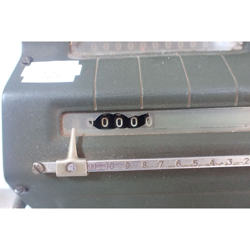 104 - A VINTAGE FACIT CALCULATOR (damage to dial cover)