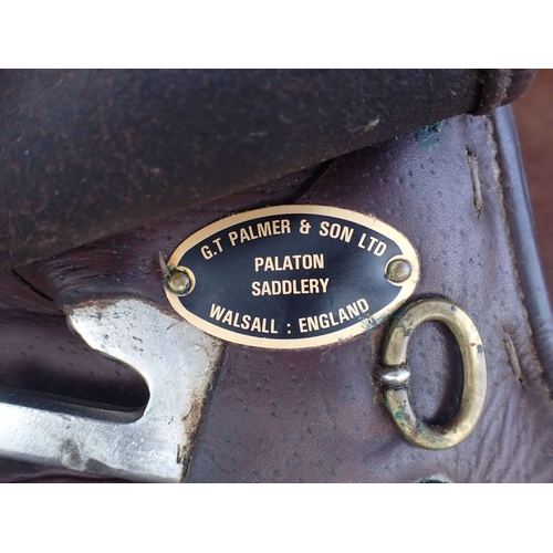 126 - A G.T. PALMER & SON HORSE SADDLE with another similar and a saddle stand