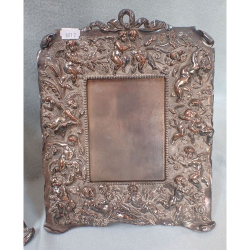 319 - A PAIR OF SILVER PLATED CHERUB RELIEF PHOTOGRAPH FRAMES 29.5 X 23 CM