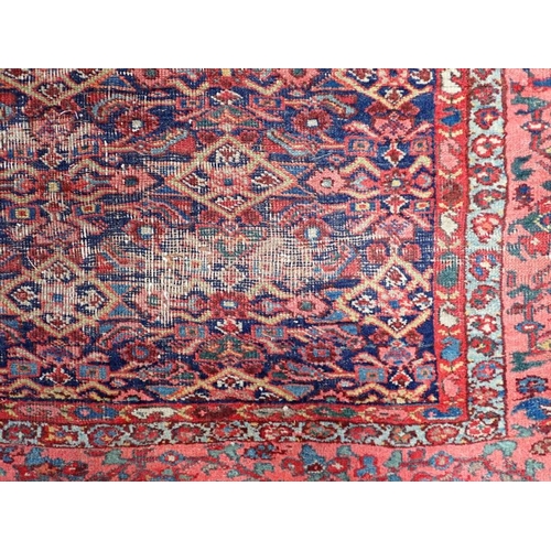 614 - A NORTH-WEST PERSIAN BIDJAR RUG, HERATI FIELD with red borders, 238 x 206cms (wear, fraying)