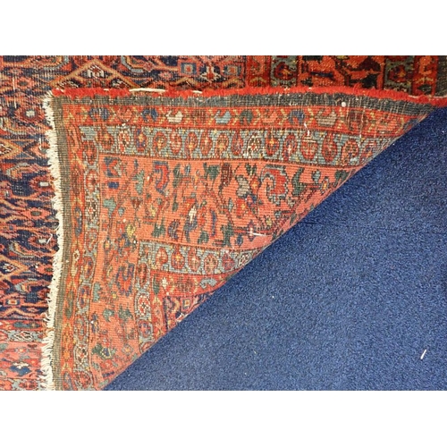 614 - A NORTH-WEST PERSIAN BIDJAR RUG, HERATI FIELD with red borders, 238 x 206cms (wear, fraying)