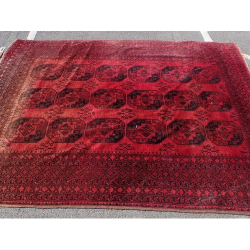 615 - A LARGE RED GROUND RUG 225 x 300cm (faded at one end, other damage) and another smaller rug 98 x 160... 