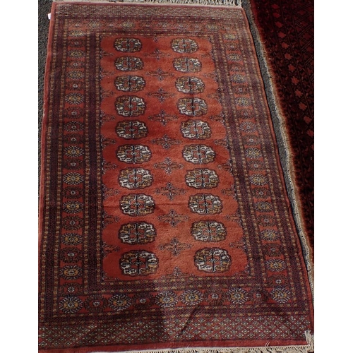 615 - A LARGE RED GROUND RUG 225 x 300cm (faded at one end, other damage) and another smaller rug 98 x 160... 