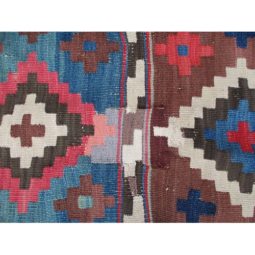 616 - A LARGE KILIM RUG 187 x 335cm (worn, patched, unevenly faded)