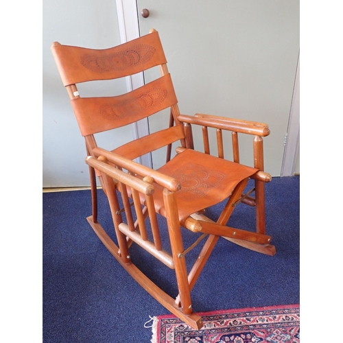 734 - A COSTA RICAN FOLDING ROCKING CHAIR with embossed leather sling seat and back