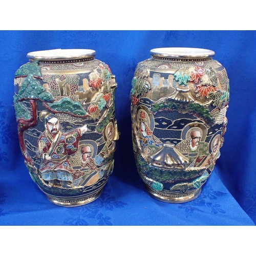 310 - A PAIR OF ORIENTAL CLOISONNE VASES ON WOODEN STANDS and a pair of Japanese relief decorated vases