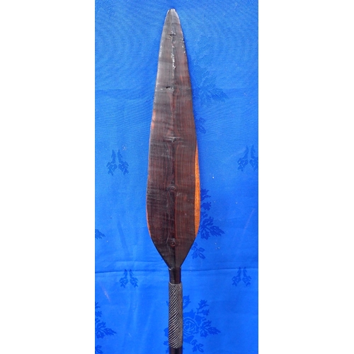 341 - TWO TRIBAL SHORT WOODEN PADDLES OR IKLWAS with another wooden spear, 116cm long