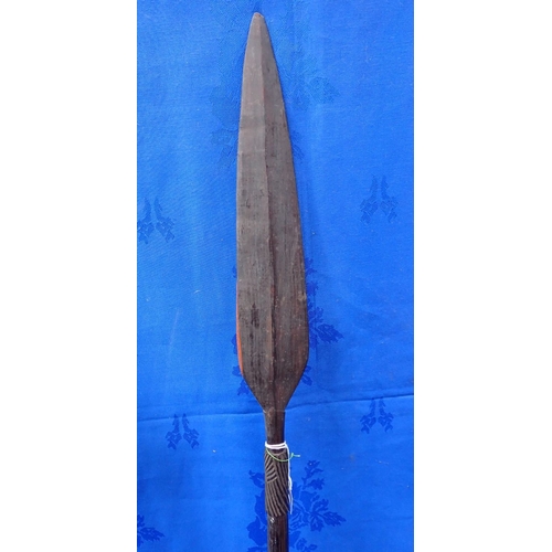 341 - TWO TRIBAL SHORT WOODEN PADDLES OR IKLWAS with another wooden spear, 116cm long