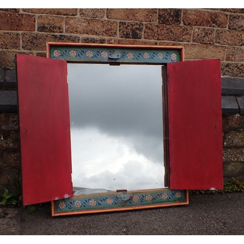 785 - A MIRROR WITH FOLK-PAINTED SHUTTERED FRAME