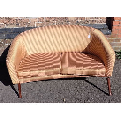 787 - A 1960S STYLE TWO-SEATER SOFA WITH ANGLED TEAK LEGS (one front leg broken off) 130cm wide