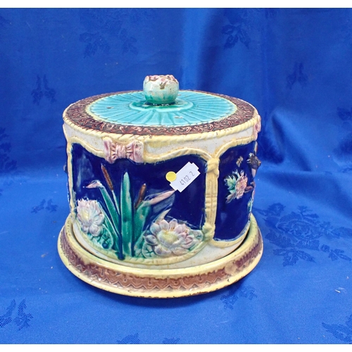 265 - A 19TH CENTURY MAJOLICA CHEESE DISH decorated with birds and bulrushes (crazed, the base cracked)