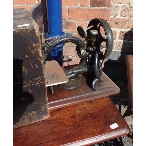 120 - A WILCOX & GIBBS SEWING MACHINE cased, two treadle sewing machines, and an iron treadle base (all fo... 