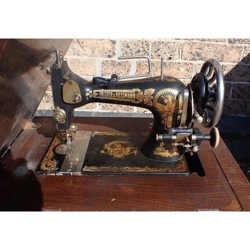 120 - A WILCOX & GIBBS SEWING MACHINE cased, two treadle sewing machines, and an iron treadle base (all fo... 