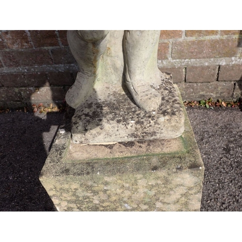 13 - A RECONSTITUTED STONE GARDEN FIGURE OF A BOY with basket of flowers, on a plinth 98cm high