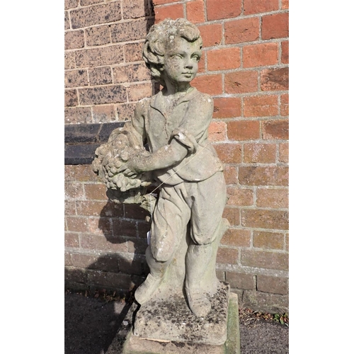 13 - A RECONSTITUTED STONE GARDEN FIGURE OF A BOY with basket of flowers, on a plinth 98cm high