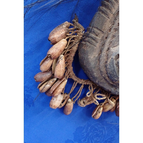 136 - A TRIBAL WOODEN MASK Papua New Guinea, inlaid shell eyes, shell fringe beard and cassawary feather d... 