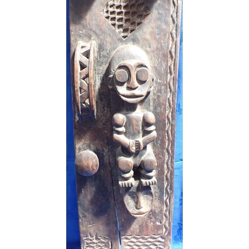 138 - A CARVED AFRICAN TRIBAL DOOR 119 cm high