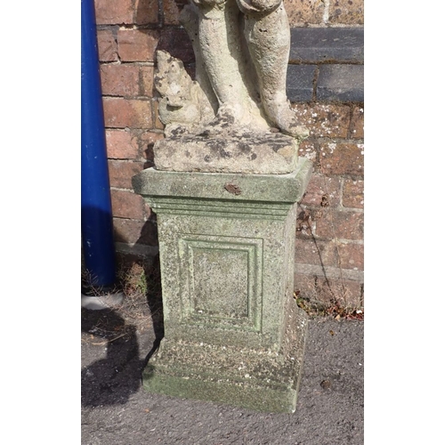 14 - A RECONSTITUTED STONE GARDEN FIGURE OF A BOY on a panelled plinth,116cm high