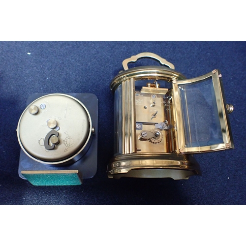 180 - MATTHEW NORMAN, LONDON: OVAL-CASED CARRIAGE CLOCK TIMEPIECE 11cm high, handle up, (not running, and ... 