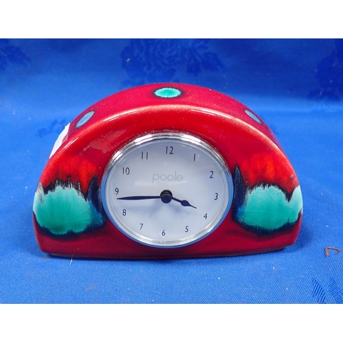 248 - A DEMI-LUNE POOLE POTTERY CLOCK in Volcano pattern, 9 cms high