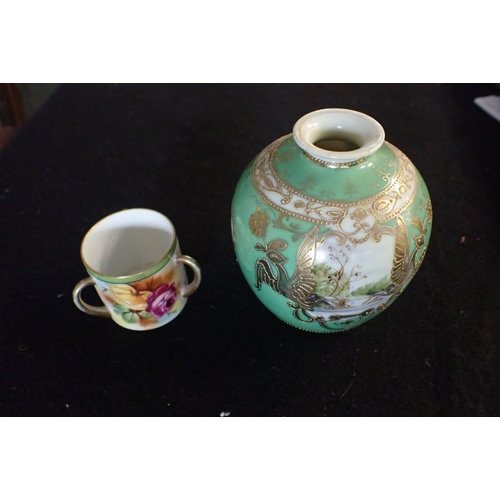 253 - A GILT AND PAINTED NORITAKE VASE AND MINIATURE LOVING CUP with an image of a head in base of cup