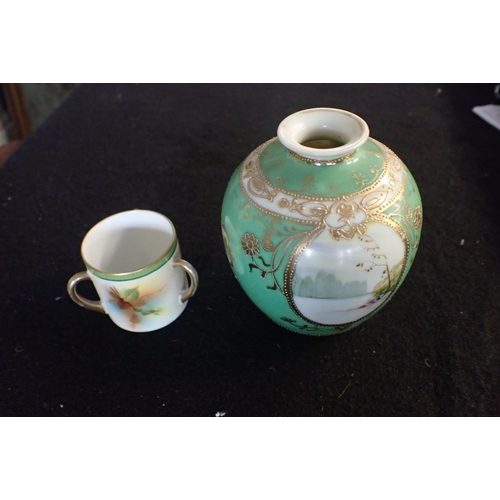 253 - A GILT AND PAINTED NORITAKE VASE AND MINIATURE LOVING CUP with an image of a head in base of cup