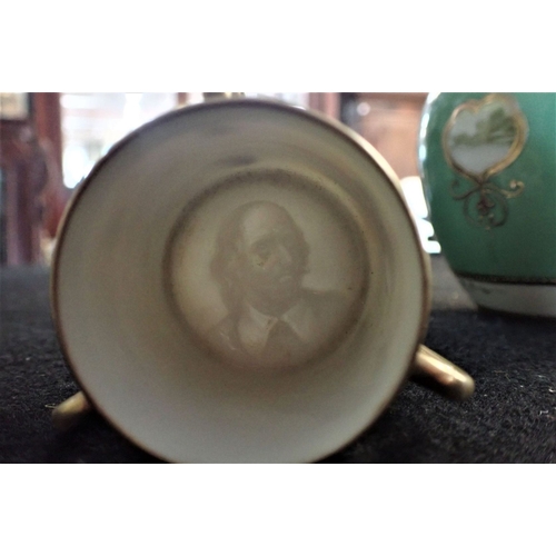 253 - A GILT AND PAINTED NORITAKE VASE AND MINIATURE LOVING CUP with an image of a head in base of cup