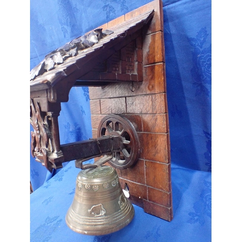 52 - A 19TH CENTURY BLACK FOREST BRACKET AND BELL 44cm high, the bell 15cm diam.