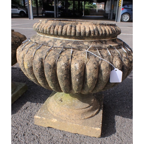 8 - FOUR RECONSTITUTED STONE GARDEN URNS (some damage)