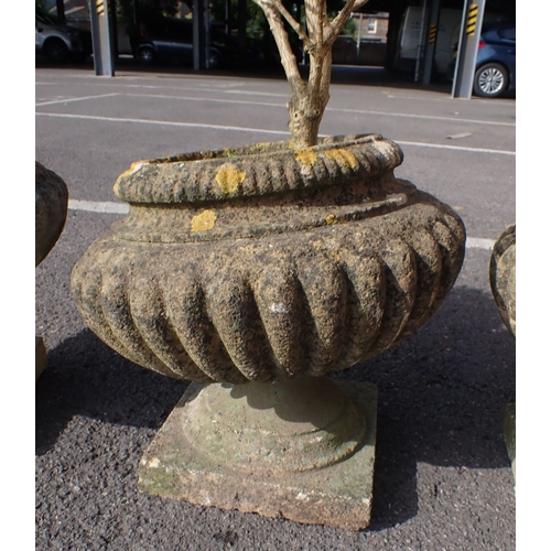 8 - FOUR RECONSTITUTED STONE GARDEN URNS (some damage)