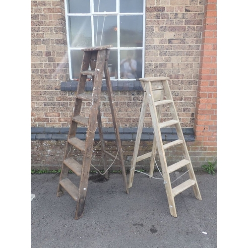 91 - TWO VINTAGE WOODEN STEPLADDERS together with a pine plinth and three round occasional table frames (... 