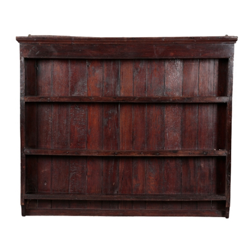 AN OAK PLATE RACK of 18th Century design, with moulded cornice and ...