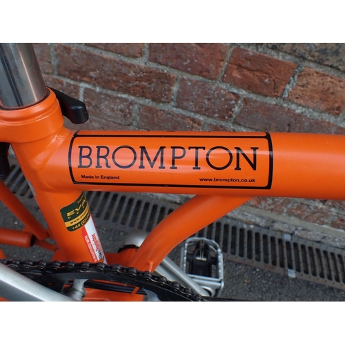 1 - A BROMPTON FOLDING BICYCLE, IN BRIGHT ORANGE three gears, bought c. 2014 (good overall condition) Re... 