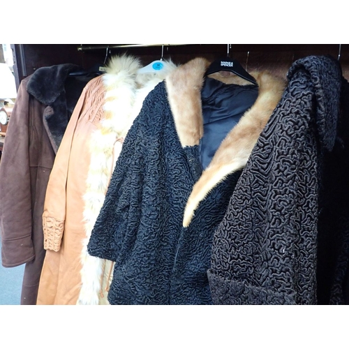 158 - A COLLECTION OF COATS including two Astrakhan, one leather, one white fur and one sheepskin coat