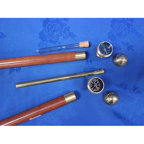 162 - A PAIR OF WALKING STICKS, BOTH WITH A COMPASS to the knob, one with an internal telescope, the other... 